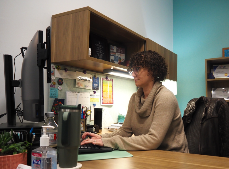 an image of Amber Hagan working at her desk in the Office for Civil Rights Compliance and Prevention Education
