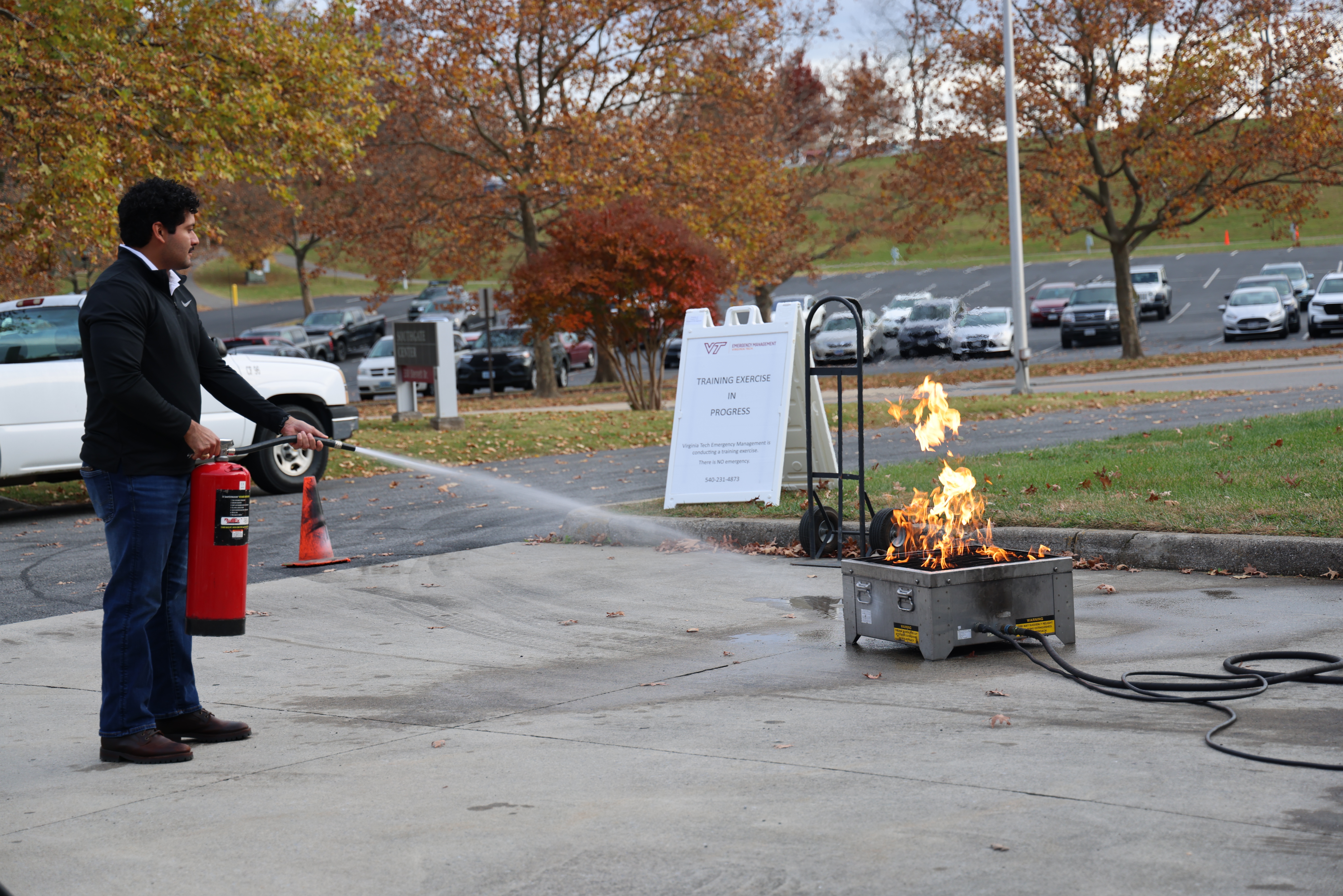 Image of an employee using a fire extinguisher during Hokie Ready Academy