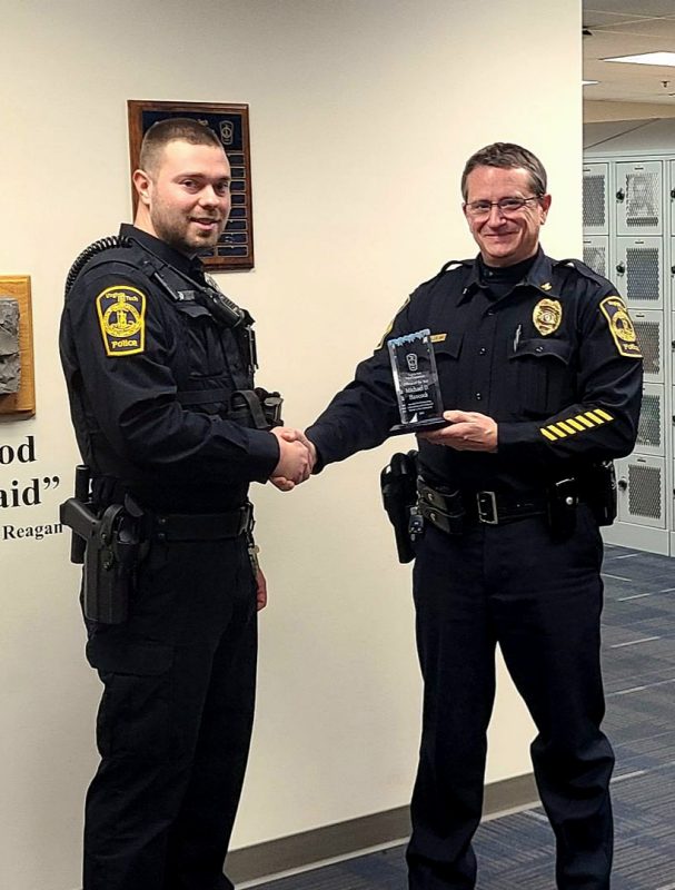 Officer Michael Hancock with Virginia Tech Police Chief Mac Babb shaking hands.